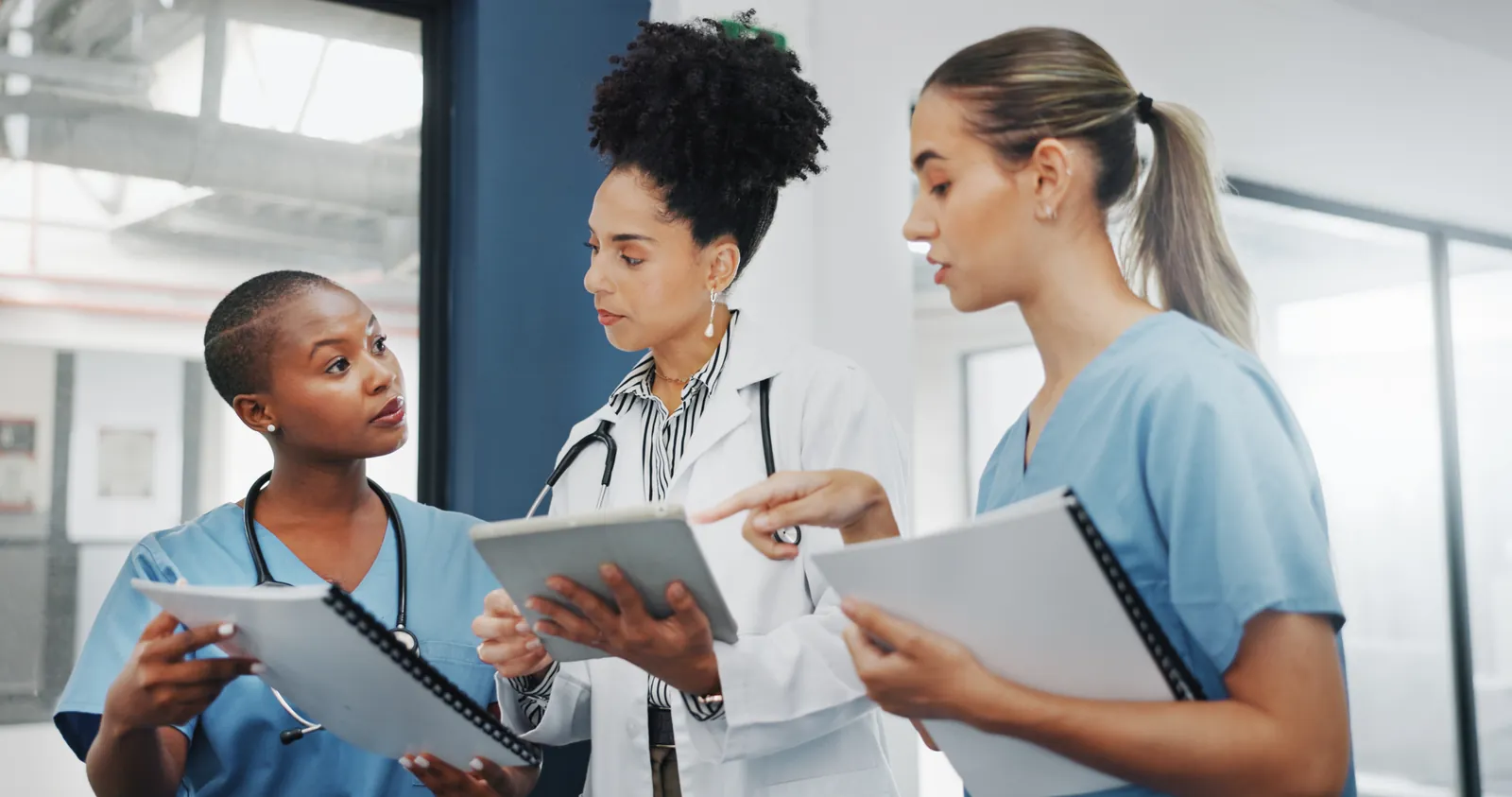 Nurses and a doctor reviewing infection-control plans together