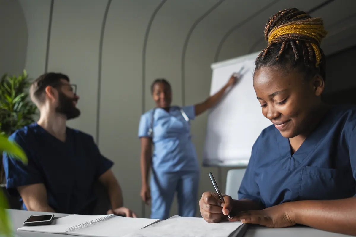 Nurses taking notes during an infection-control training session